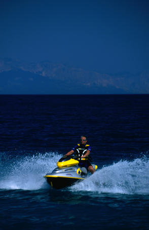A man riding a jet-ski in the waters off Brac Island.