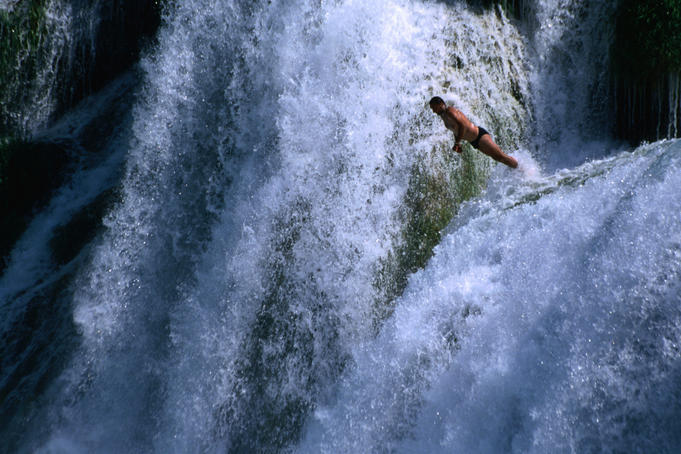 Man leaping off one of the Skradinski Buk waterfalls.