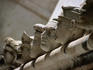 A row of carved stone heads on top of the walls outside the apse of the Cathedral of St Jacob.