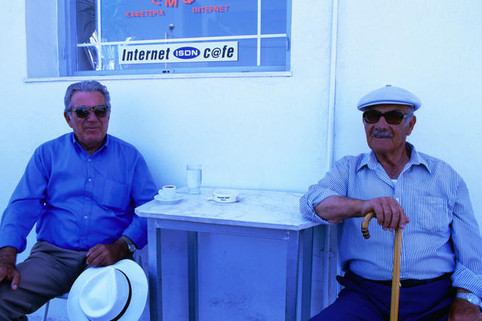 Two men outside an internet cafe.