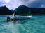 Local pension owner cruising his dinghy along the peninsula called Tahiti Iti near the Te Pari cliffs.