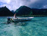 Local pension owner cruising his dinghy along the peninsula called Tahiti Iti near the Te Pari cliffs.