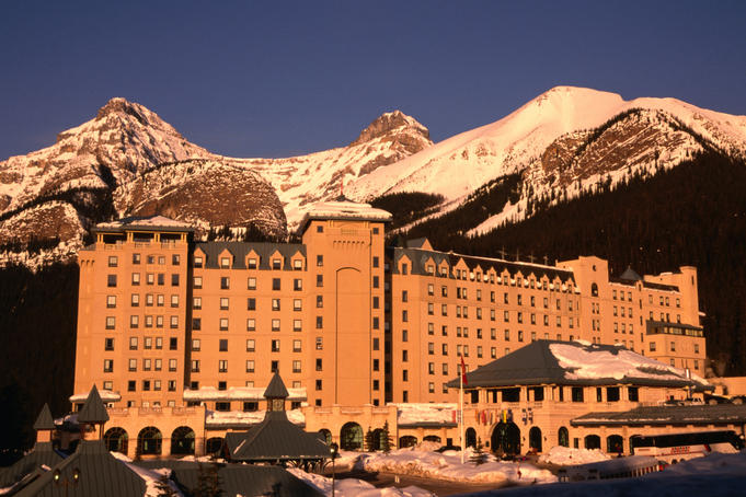Facade and entrance of the Chateau Lake Louise basking in the afternoon sun, Banff National Park.