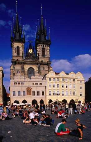Young people relaxing on Stare Mesto Square.
