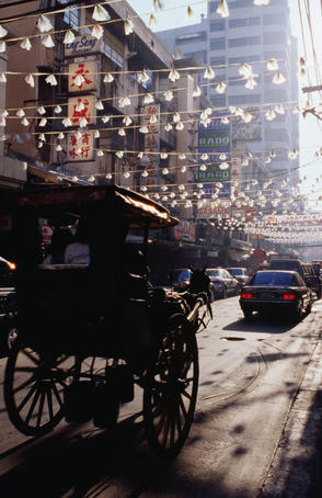 Horse drawn carriage through Chinatown in Manila.