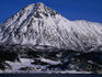 Snow-covered coastal mountain in the Arctic Circle.