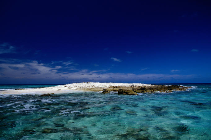 Funafuti Atoll, December 2000. The tiny islet of Tepuka Savilivili has been cited as possible evidence of climatic change, as its coconut trees and sandbanks have disappeared leaving it just a small stretch of rock.