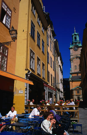 Cafe in the Stortorget square looking towards a corner of the Tyska Kyrkan, a lavishly decorated German church in the Gamla Stan district or Old Town, Stockholm.