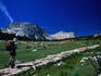 Hiker near Tuolumne Pass (3997m) on Rafferty creek in the Tuolumne Meadows region, approaching the granite peaks of Fletcher (4563m) and Vogelsang (4602m), in the High Sierras of Yosemite National Park.