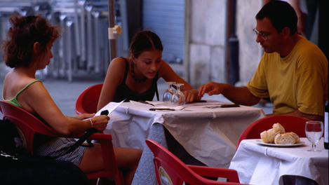 Ordering a meal at a restaurant in the Plaza de la Virgen.