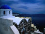 Typical whitewashed and blue dome of a church facing the caldera in Oia, Santorini island.