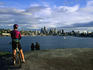 Cyclists and couples take in the Seattle skyline and Union Lake from the Gasworks Park.