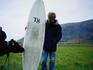 A local sniffs the wax on a visiting surfers board in the coastal village of Unstad in Lofoten.