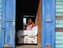 Woman looking through her door from her couch.