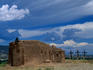 A traditional adobe building on Tome Hill with 3 symbolic crosses. The crosses were erected by Edward Berry after his return from WWII to Alburquerque.