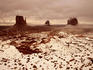 Snow covered valley and rock formations.