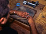 Man making cigars by hand.