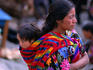 Mayan woman carrying her baby in a sling on her back.
