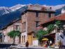 Village buildings beneath Pirin Mountains.
