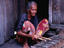 Woman plays xylophone, Kampung Penambawan, Malaysia