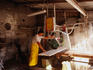 A worker slicing slabs of marble with a machine in a marble factory.