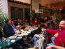 Good food, wine and music bring a group of people together in an outdoor restaurant.
