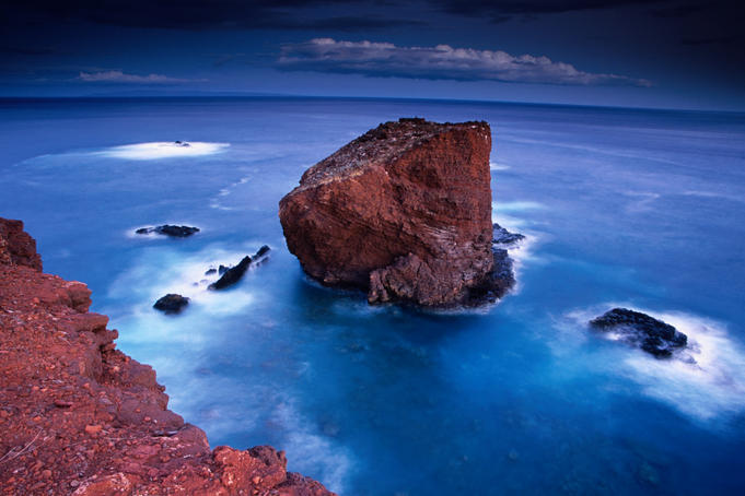 Puu Pehe (Sweetheart Rock) at dusk from atop the Pali Lei no Haunui (cliffs) at Manele Bay, Lanai.