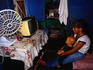 Favela Paraisopolis, slum or shanty town: Young girl watching television inside - Sao Paulo, Sao Paulo
