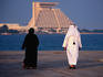 Arabs at the Corniche with Sheraton Hotel behind.