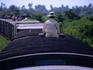 A man sitting alone on the roof of a carriage of the Battambang to Phnom Penh train.