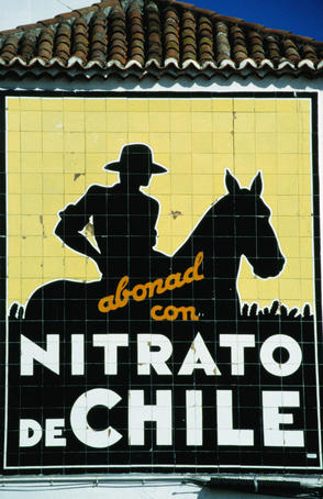 A tiled sign, featuring the silhouettes of a man riding a horse, in Plaza de la Constitucion