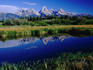 The Grand Tetons reflected in small tarn.