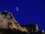 Moonrise over a rocky mountain ridge in Waterton National Park.
