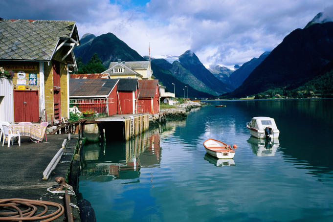 Quayside buildings and boats on fjord.
