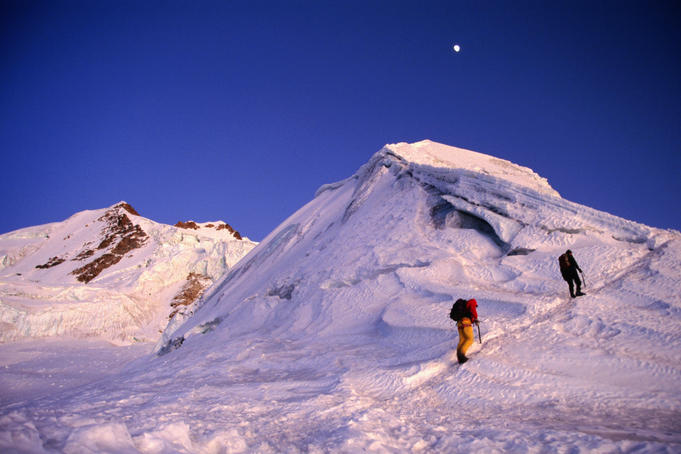 Mountaineers climbing ridge on mountain.
