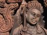 Close-up of a female divinity adorned with heavy earrings and elongated earlobes, at the late 10th century Banteay Srei temple.