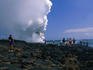 Tourists walk out to the smoking lava flow in the Hawaii Volcanos National Park.