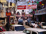 Advertising banners and flags overhang a street in Delhi.