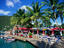 Shops and restaurants, under the shade of palm trees, on the waterfront at West End.