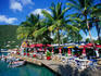Shops and restaurants, under the shade of palm trees, on the waterfront at West End.