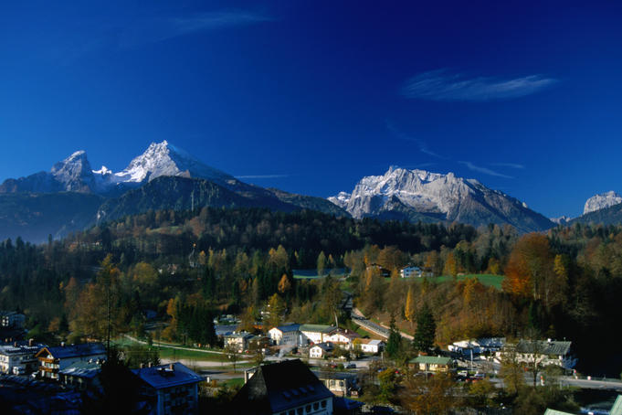 Mittelspitze (2713m, the second tallest mountain in Germany) on the left and Hochkalter (2607m) on the right, both towering over the town of Berchtesgaden at sunrise.