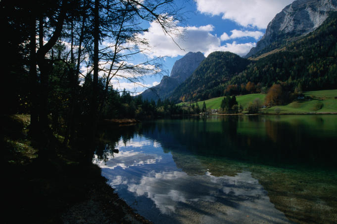 Clouds above, and reflected in, the still waters of Hintersee in the Bavarian Alps.