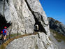 Hikers on Hohenweg with the tunnel leading from the top down to Lake Lucerne.