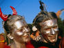 Couple with silver painted faces/hair and a devilish smile at the Streetparade.
