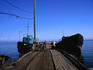 Ships docked alongside the wooden jetty in the picturesque village of Baikalskoe, North Lake Baikal.