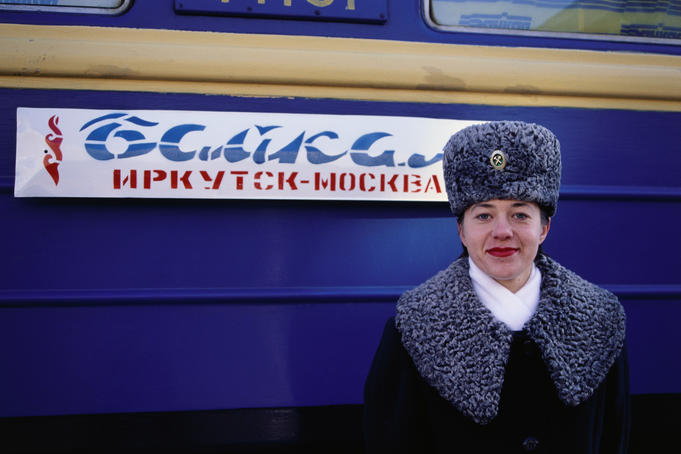 A Prodvodnista (carriage attendant) standing in front of No 9 and 10 Baikal train.