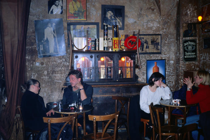 Customers sit in the rustic interior of the Blue Light Jazz Bar in Mala Strana.