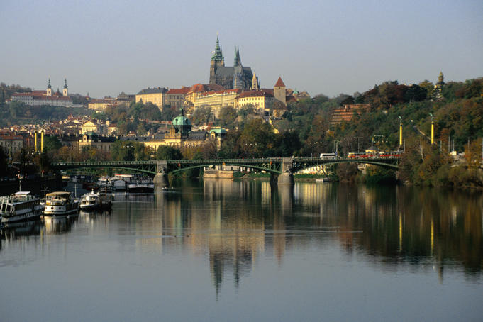 Prague Castle and Strahov Monastery reflecting on Vltava River.