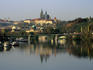 Prague Castle and Strahov Monastery reflecting on Vltava River.