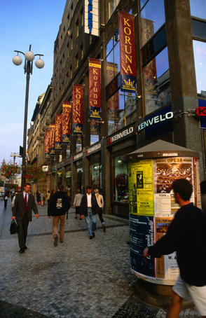 Shoppers in front of the Koruna building stroll along Na Prikope Street in Prague.